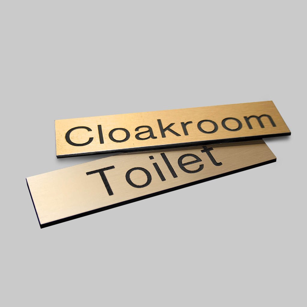 Engraved Sign With Adhesive Backing - 140 x 35mm Dia Black Text On Brass Effect - Ready Set SuppliedEngraved Sign With Adhesive Backing - 140 x 35mm Dia Black Text On Brass Effect51497
